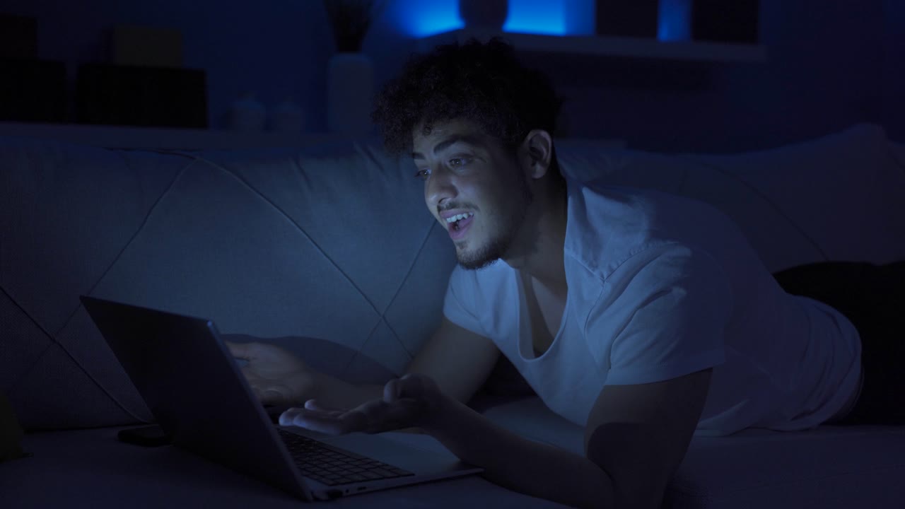 Seeing his failure on the laptop, the young man gets angry.