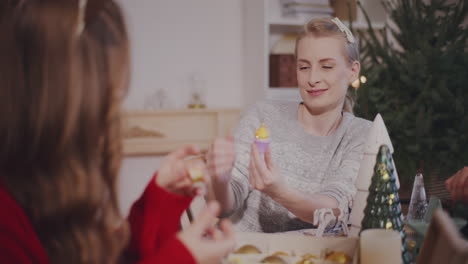 woman talking to female friend with decoration at home