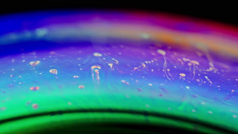 vibrant macro shot of swirling iridescent soap film with colorful abstract textures