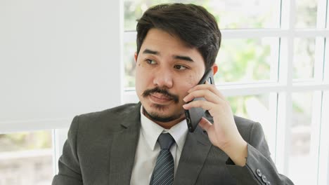 slow motion scene adult middle east businessman use smartphone to call and talk with partner or colleagues to advice and consult about work for lifestyle business concept