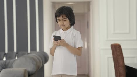 Angry-Indian-boy-texting-someone-on-phone