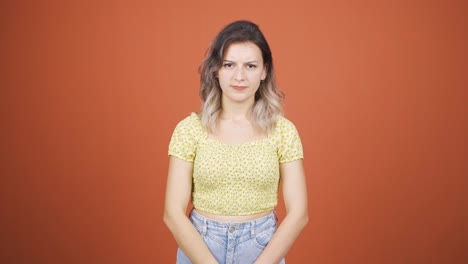the young woman is warning by looking at the camera.