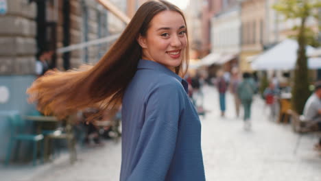 Rear-view-of-young-woman-tourist-walking-through-the-street-outdoors,-looking-searching-for-a-way