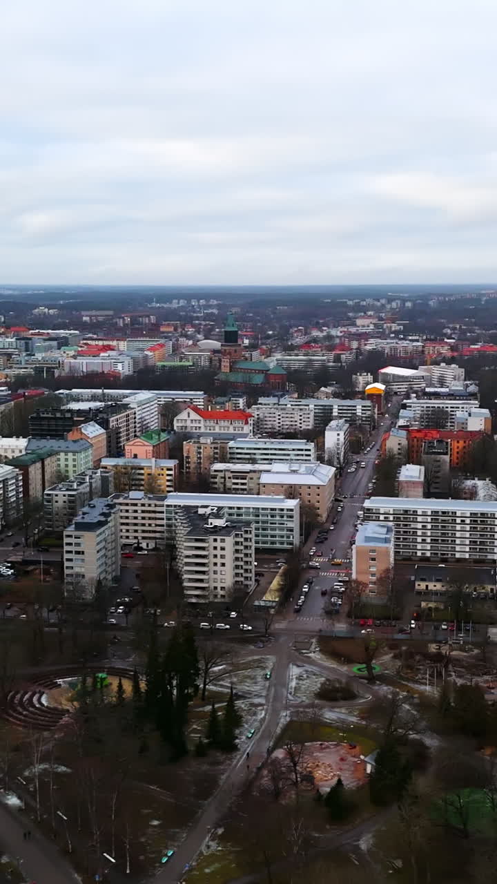 Vertical drone shot in front of condos of Turku city, wet, cloudy day in Finland