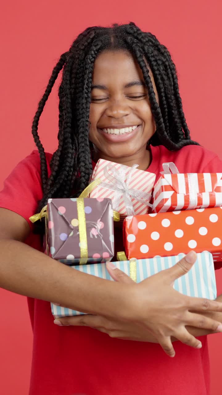 Woman Holding Stack of Gifts