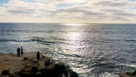 People-enjoy-a-California-sunset-amongst-sea-lions