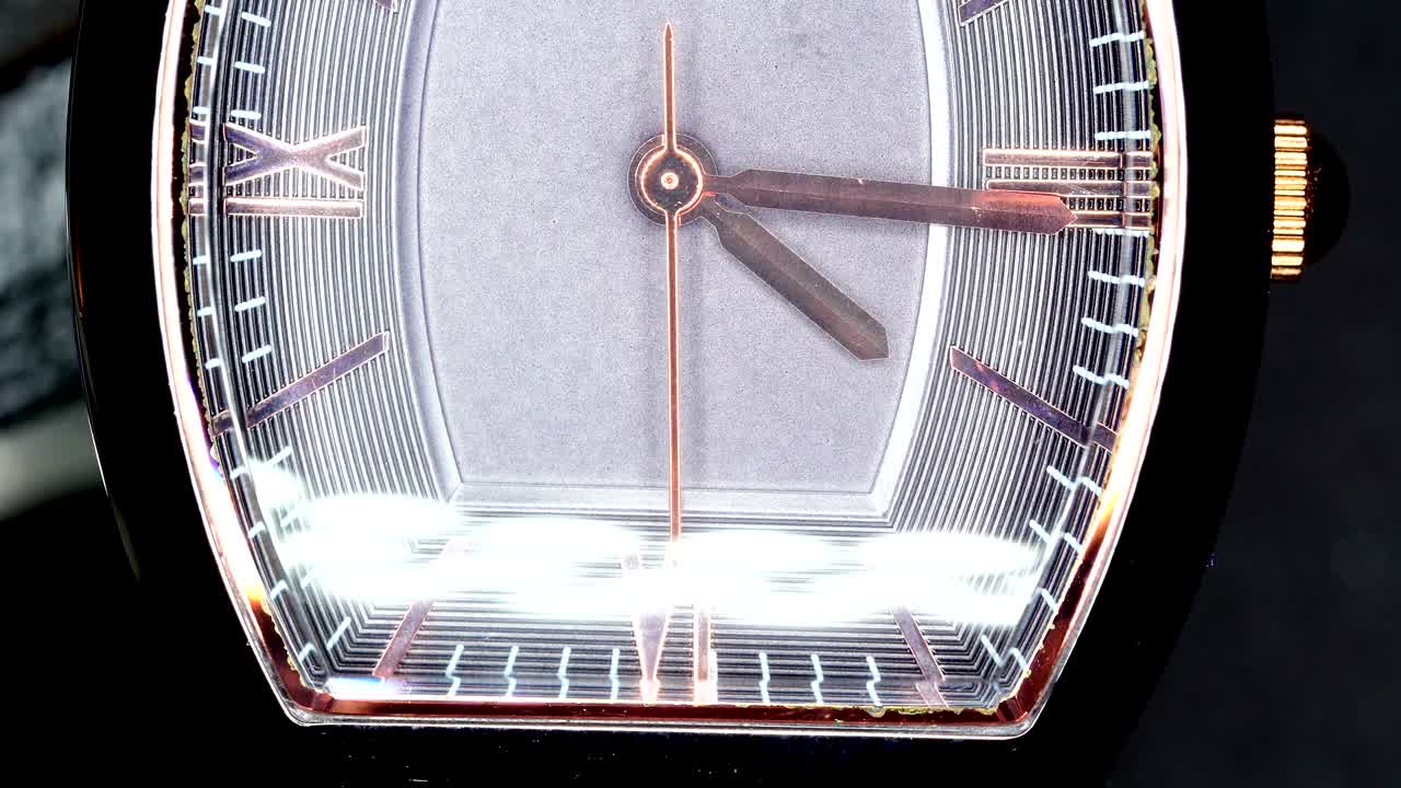 A macro shot of the silver wrist watch with the second hand