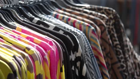 clothes hanging on racks in a store