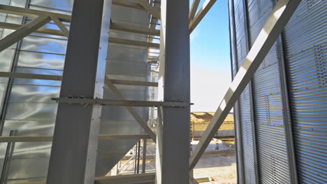 modern warehouse. metal frame on industrial plant. grain elevator. storage tanks with metal equipment outdoors.