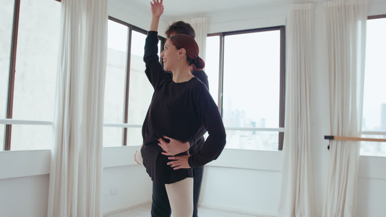 Young Couple of Ballet Dancers Rehearsing in a Studio
