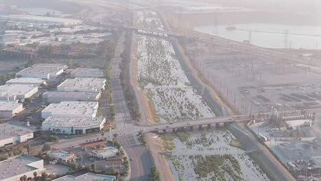 Aerial-View-of-Santa-Fe-Dam-Filled-with-Historic-Rainfall-and-Water-Flowing-Down-Channel