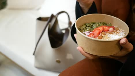woman eating a healthy yogurt parfait