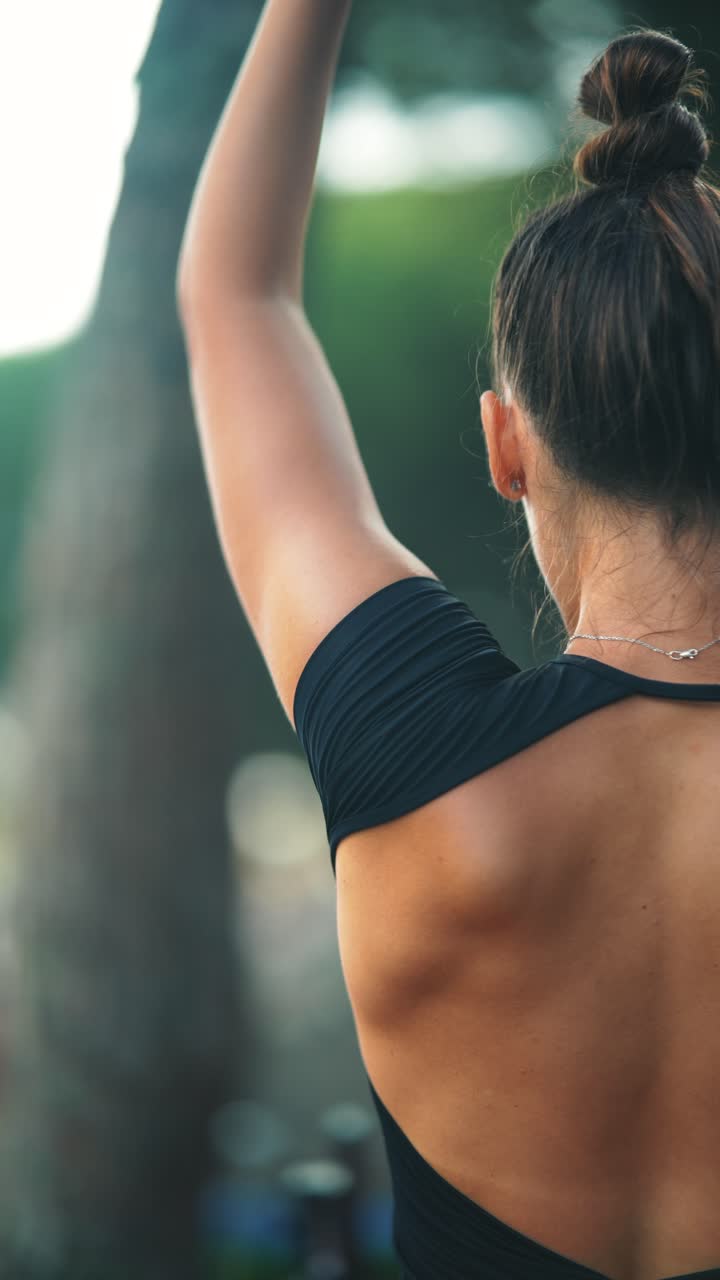 Woman exercising outdoors showing back muscles