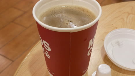 steaming morning coffee close-up: creamer detail and cozy vibes