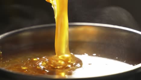 captivating flow of golden liquid: a close-up journey into the rich texture and viscosity of honey as it pours into a bowl, showcasing its luxury and sweetness