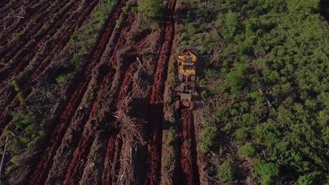 aerial drone shot of soil prepartion machine preparing agriculture land in posadas of misiones argentina