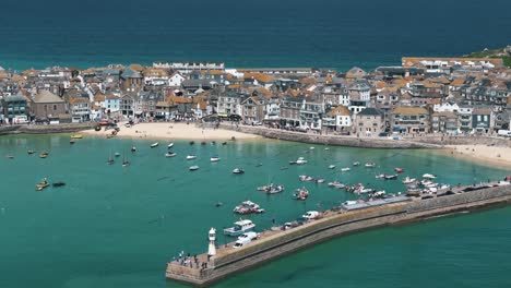descending drone pan up over vivid st ives bay with deep blue ocean beyond
