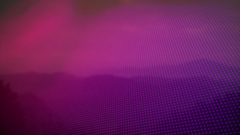 animation of blue to orange rows of spots over mountains in background