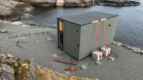 small hytters, or cabins, for travelers located along the coast which are held down with weights to prevent them from being blown into the sea as happened in february 2023 during a powerful storm