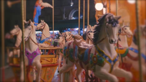 a colourful carousel with lights and horses on a evening