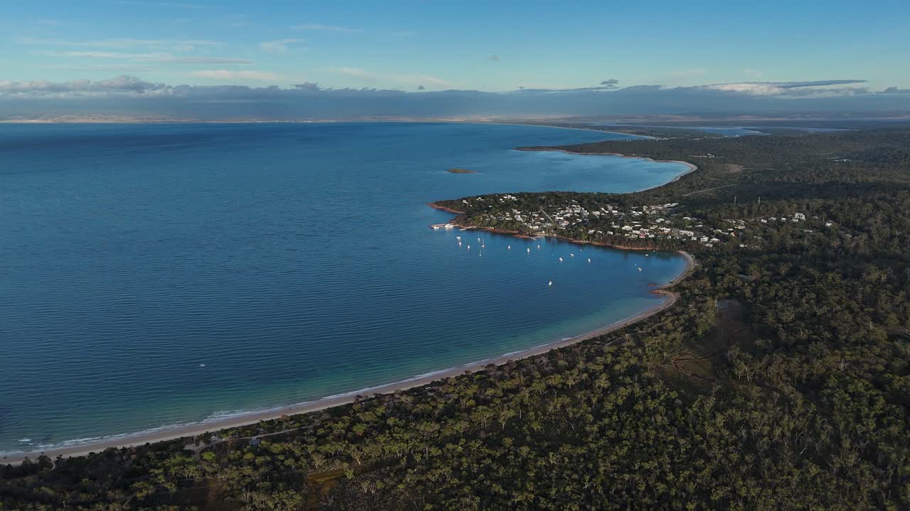 Aerial view over the Coles Bay Conservation Area and Freycinet town at sunset.