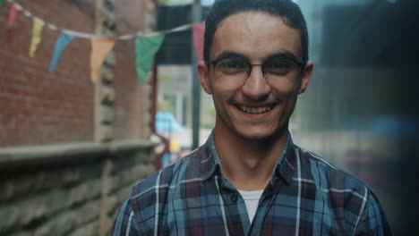 happy young man in an alley