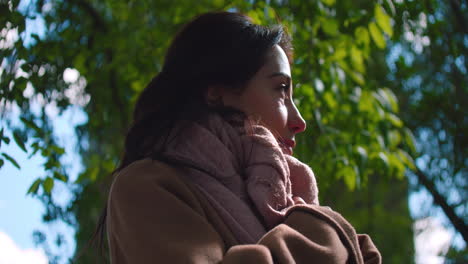 Portrait-Of-A-Beautiful-Woman-Wearing-Scarf-Around-Her-Neck-On-A-Sunny-Wintertime