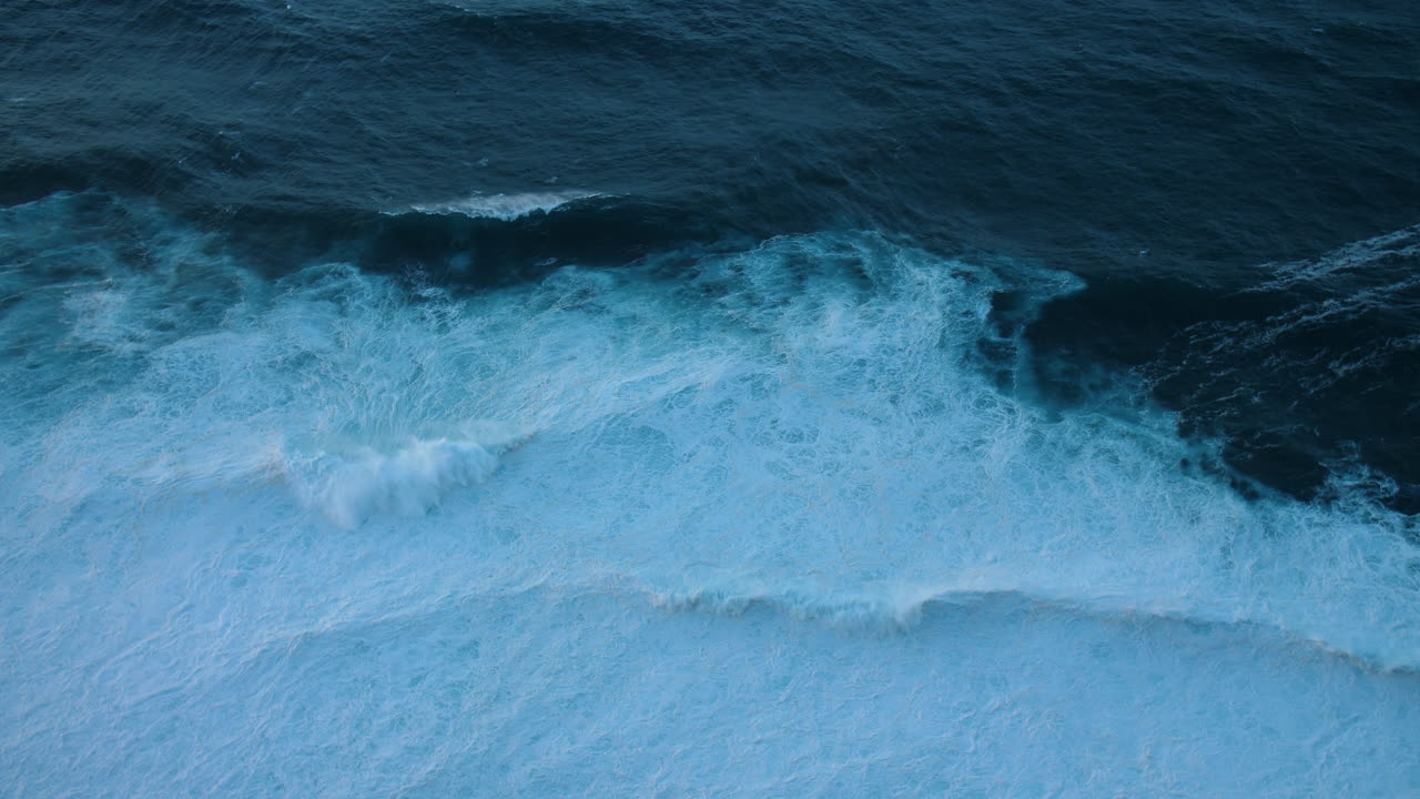 Aerial View of Powerful Ocean Waves Crashing on the Shore