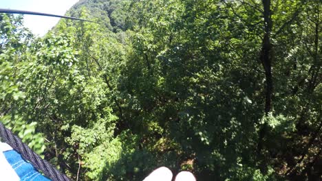 one person gliding on zip line on fun adventure excursion, pov