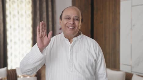 Old-Indian-man-doing-Hello-and-waving-hand