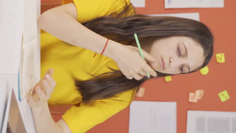 vídeo vertical de una niña estudiando en una computadora portátil chateando en facetime.