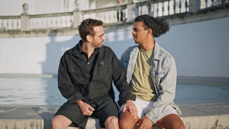 two men talking by a fountain