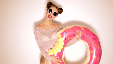 woman posing with inflatable donut