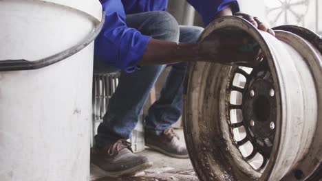 african man cleaning a wheel