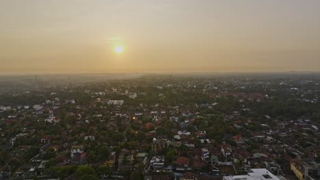 Negombo-Sri-Lanka-Aerial-v2-drone-flyover-Kattuwa-residential-area-capturing-seafront-hotels-along-Wellaweediya-beach-with-glowing-sun-rising-above-horizon---Shot-with-Mavic-3-Cine---April-2023