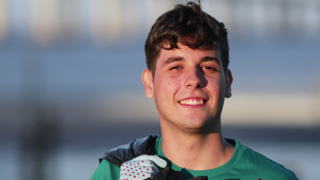 un joven voluntario alegre sonriendo a la cámara