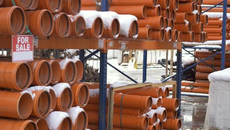 orange pvc pipes stacked in construction site