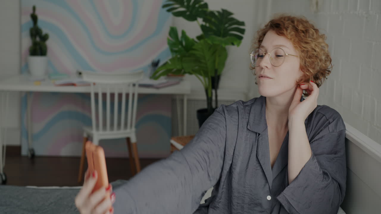 Woman Taking a Selfie in Pajamas