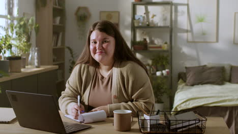 young woman working at home