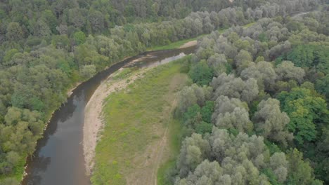 Aerial-over-head-shot-down-river-flowing-in-Europe-that-appears-to-be-disappearing-during-the-drought