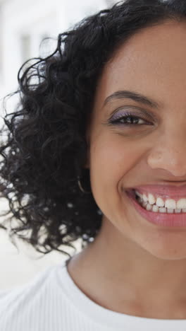 vertical video of half portrait of biracial woman at home, slow motion