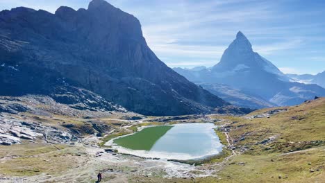 mountain freedom: matterhorn mountain landscape near rotenboden and gornergart, switzerland, europe | shaky movement down trail overlooking scenic lake and travel couple, hiking