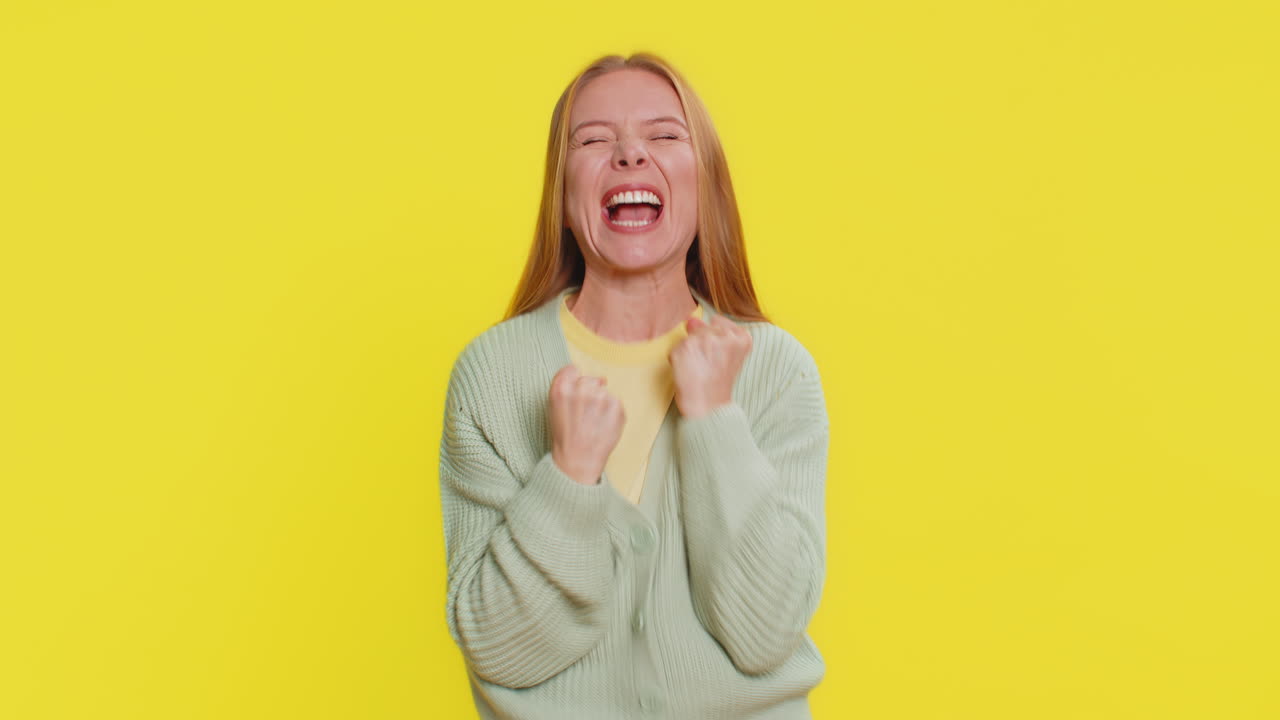 Happy mature woman celebrating success winning victory lottery jackpot goal achievement good news