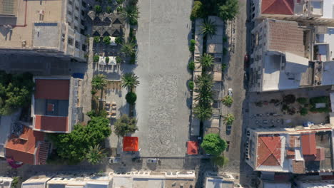 Top-down-drone-shot-of-Miaouli-Square-in-Ermoupoli-of-Syros,-Greece-during-sunrise