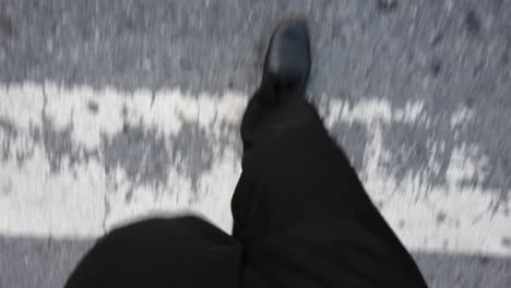 slowmotion view of the man while walking on the foot-path