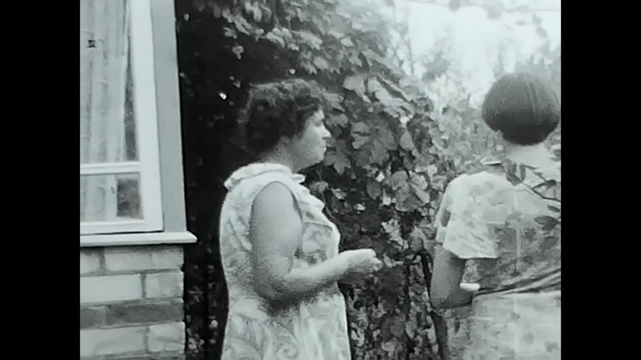 Group of People Standing Outside of a House in the Soviet Union. CIRCA USSR 1970: A snapshot of Soviet people gathered outside a house during the era of USSR communism and socialism.