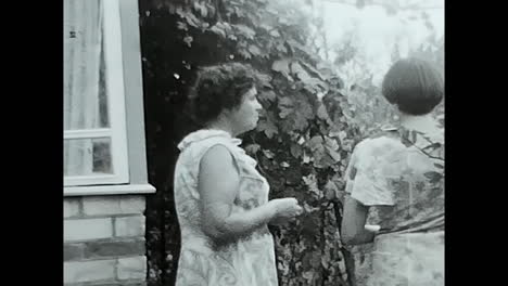 group of people standing outside of a house in the soviet union. circa ussr 1970: a snapshot of soviet people gathered outside a house during the era of ussr communism and socialism.