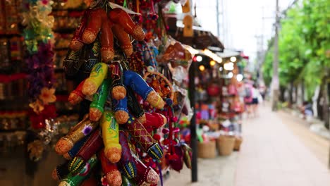 tourists explore vibrant market with wooden toys