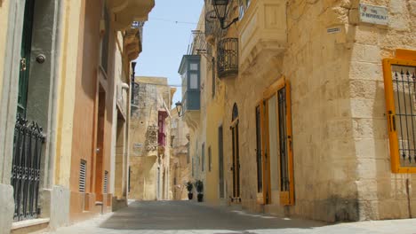 medieval architecture along empty street due to spread of covid-19 in rabat, malta