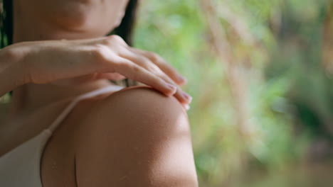 woman hand touching skin tropical resort closeup. model running fingers at arm